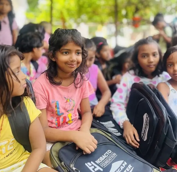 Children receiving school bags at Maya Nagri, Bhilai — NOBACTO FOUNDATION Action 01