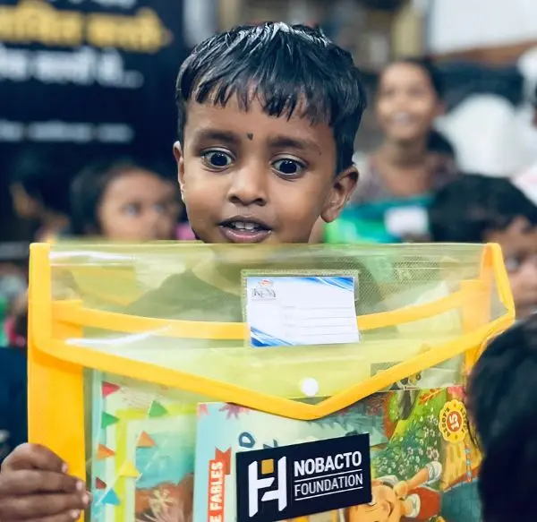 Children receiving activity kits and dental checkups at Ruabandha Bustee, Bhilai — NOBACTO FOUNDATION Action 02